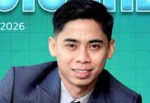 Dirut PDAM Lombok Timur Apresiasi Dedikasi Pekerja Sebagai Mesin Pembangunan Foto close-up Sopyan Hakim mengenakan setelan jas formal biru tua dengan latar belakang desain grafis berwarna hijau toska bertuliskan Mei 2026.